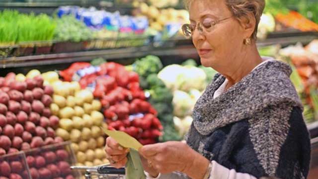 Woman shopping for produce in the grocery store